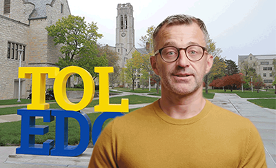 AI-generated Doug Reynolds standing in front of University Hall