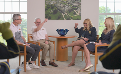 UToledo Foundation board members sitting around a table with UToledo President, Dr. James Holloway